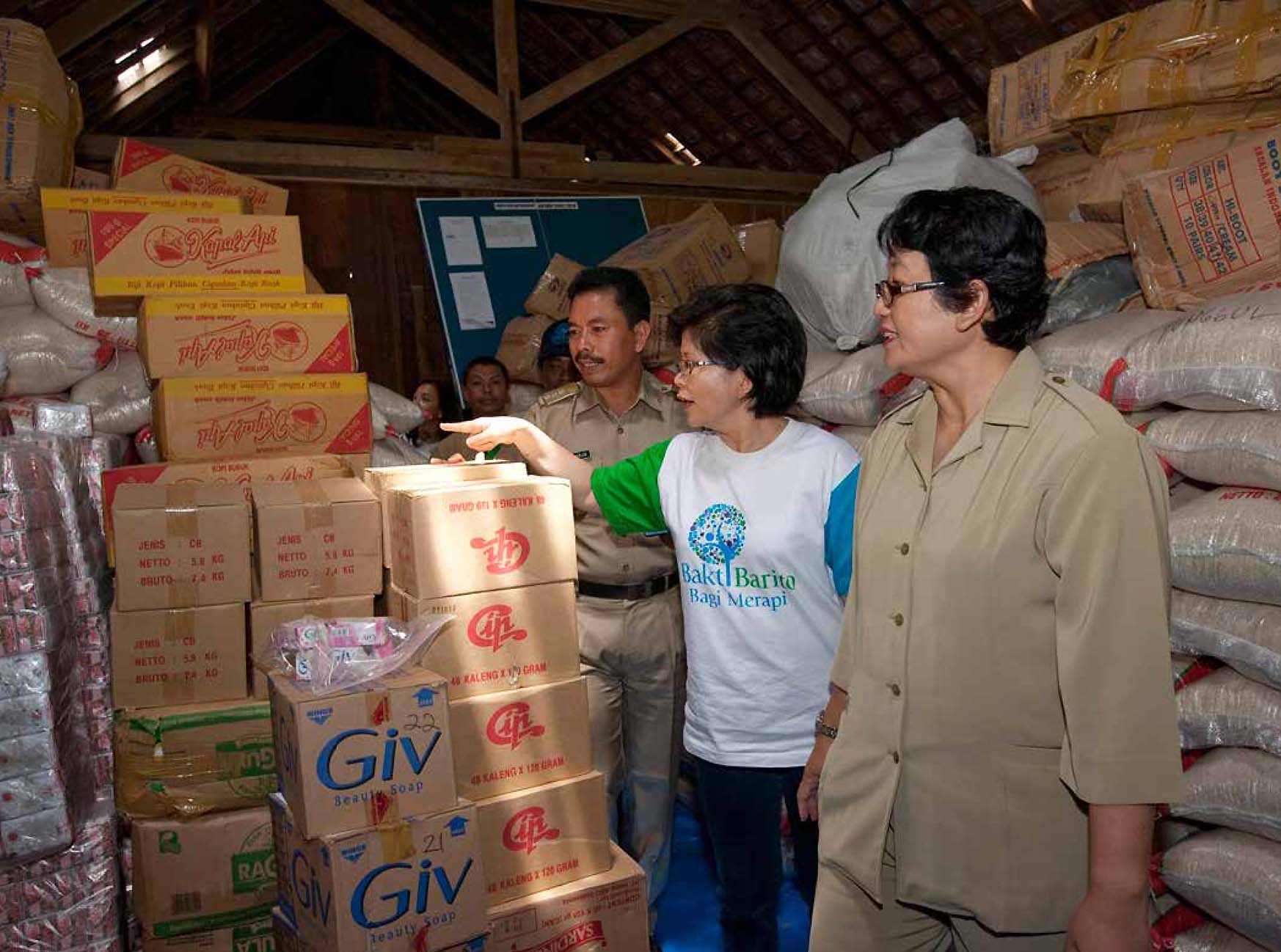 Volunteers from the Bakti Barito Foundation organize boxes of basic necessities in a warehouse as part of the disaster relief efforts for the 2010 Mount Merapi volcanic eruption.