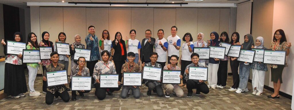 Recipients of the Barito Pacific Scholarship posing with their award certificates and company representatives during a formal ceremony.
