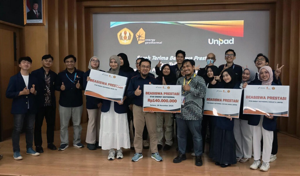 Scholarship recipients and facilitators celebrate together while holding achievement scholarship boards at a university event